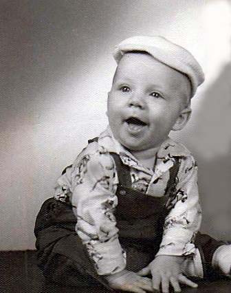 Faron Collins in a hat and baby clothes